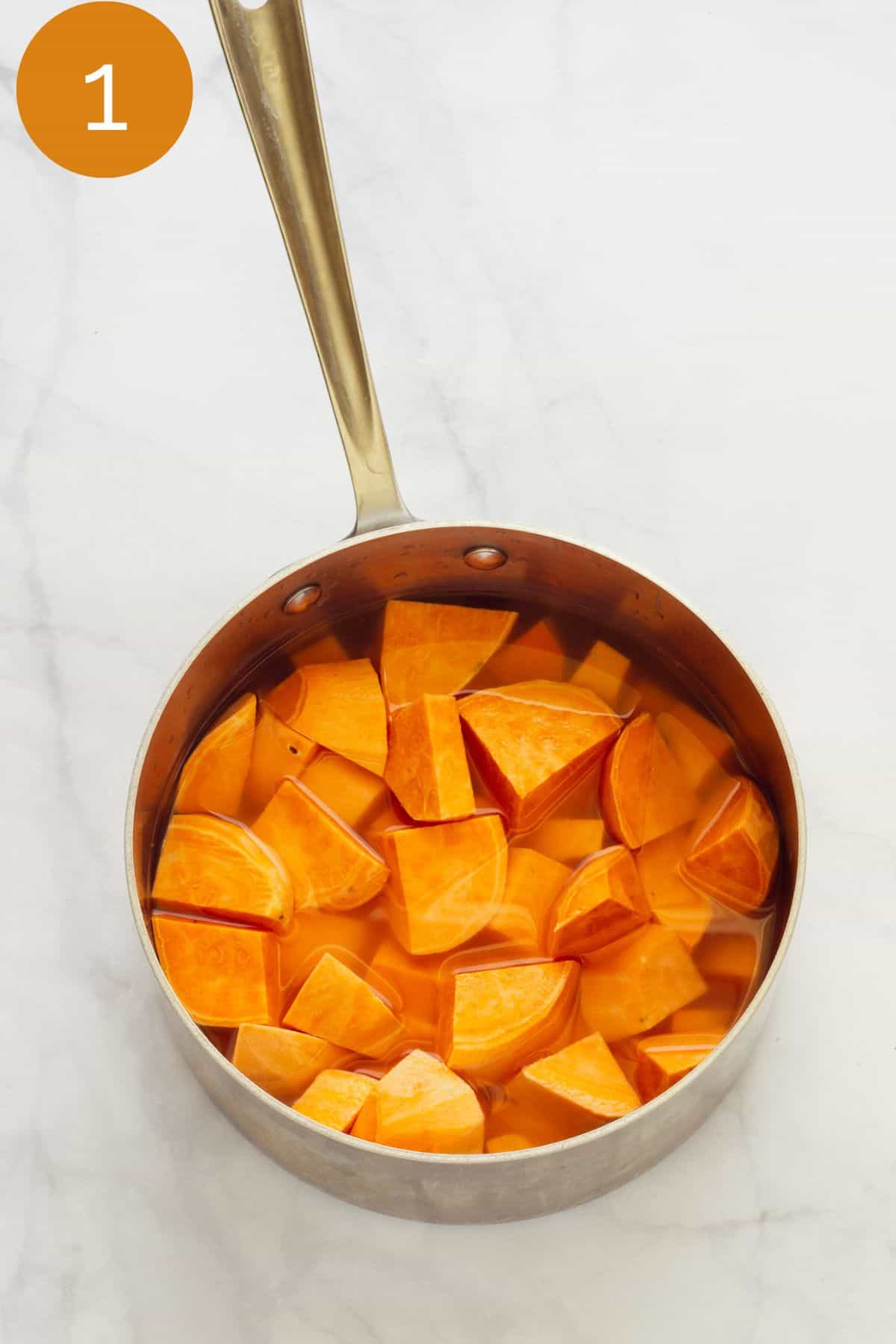 a saucepan with cubes of sweet potatoes.