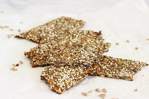 Homemade Grain Free Six Seed Flatbread Crackers on a sheet of parchment paper