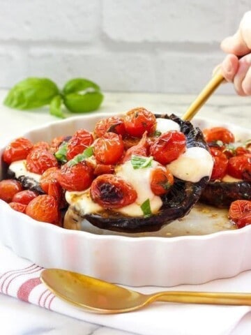 A baking dish with Caprese-stuffed portobello mushrooms