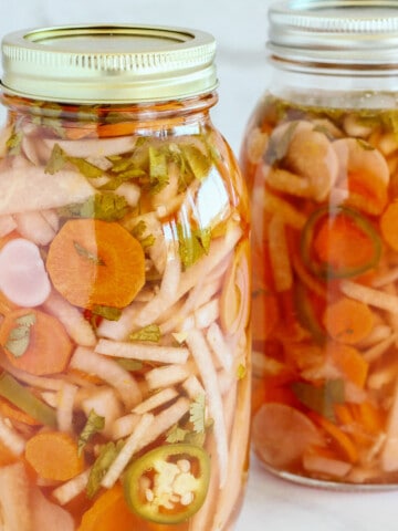 2 mason jars filled with Mexican pickled vegetables.