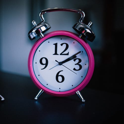 a round, pink alarm clock