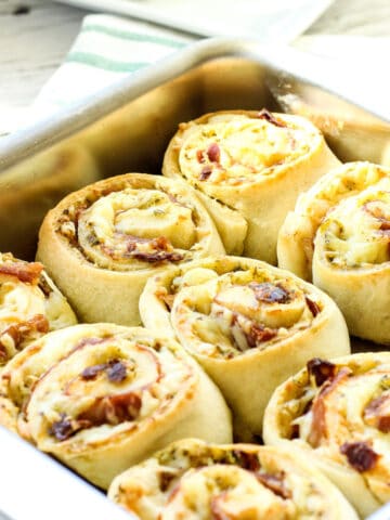 A baking pan of prosciutto and cheese pinwheels