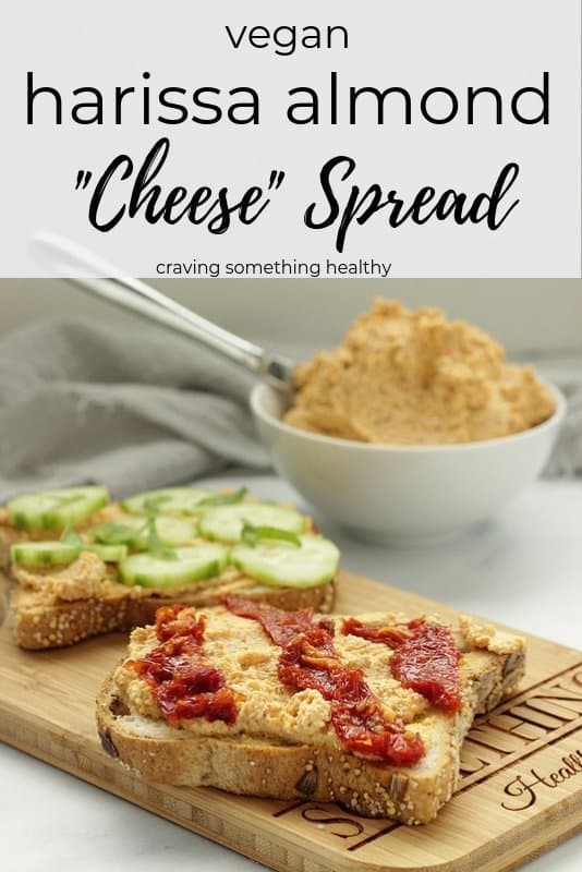 Vegan Harissa Almond Cheese spread on toast and topped with cucumbers and sun-dried tomatoes  